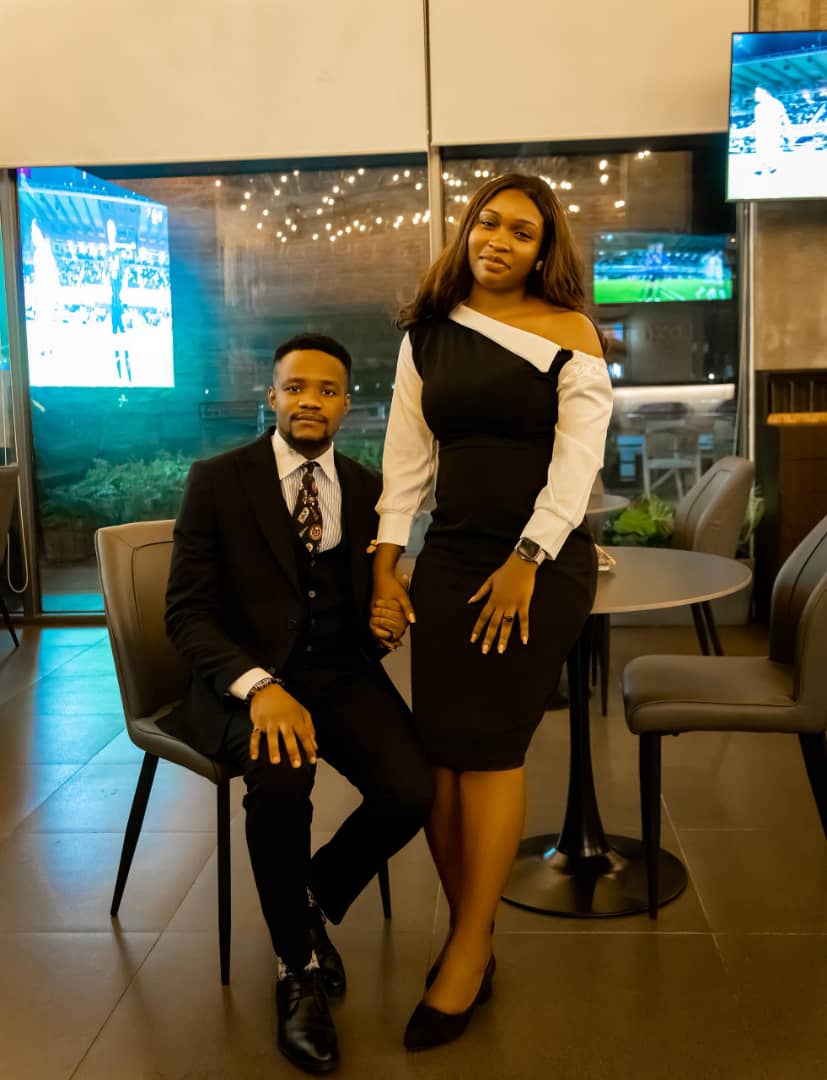 Kent and Iheoma in elegant black formal outfits at their engagement
