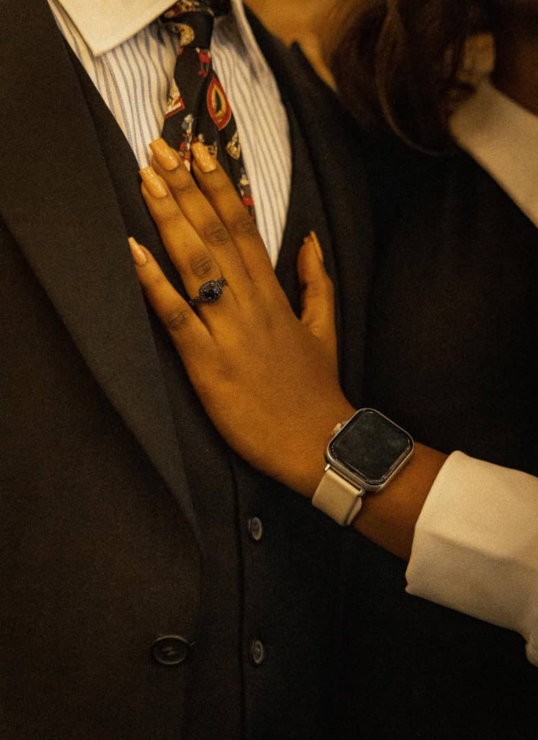 Close-up of Iheoma's hand showing her engagement ring on Kent's chest